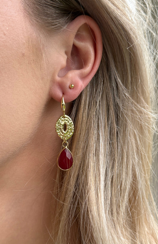 Kleine bordeauxrode natuursteen druppel aan een dichte connector