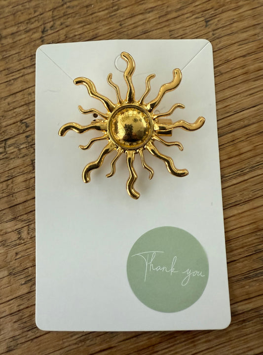 Broche zon